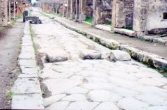 Pedestrian causeway across Via dell'Abondanza with slots for cart wheels